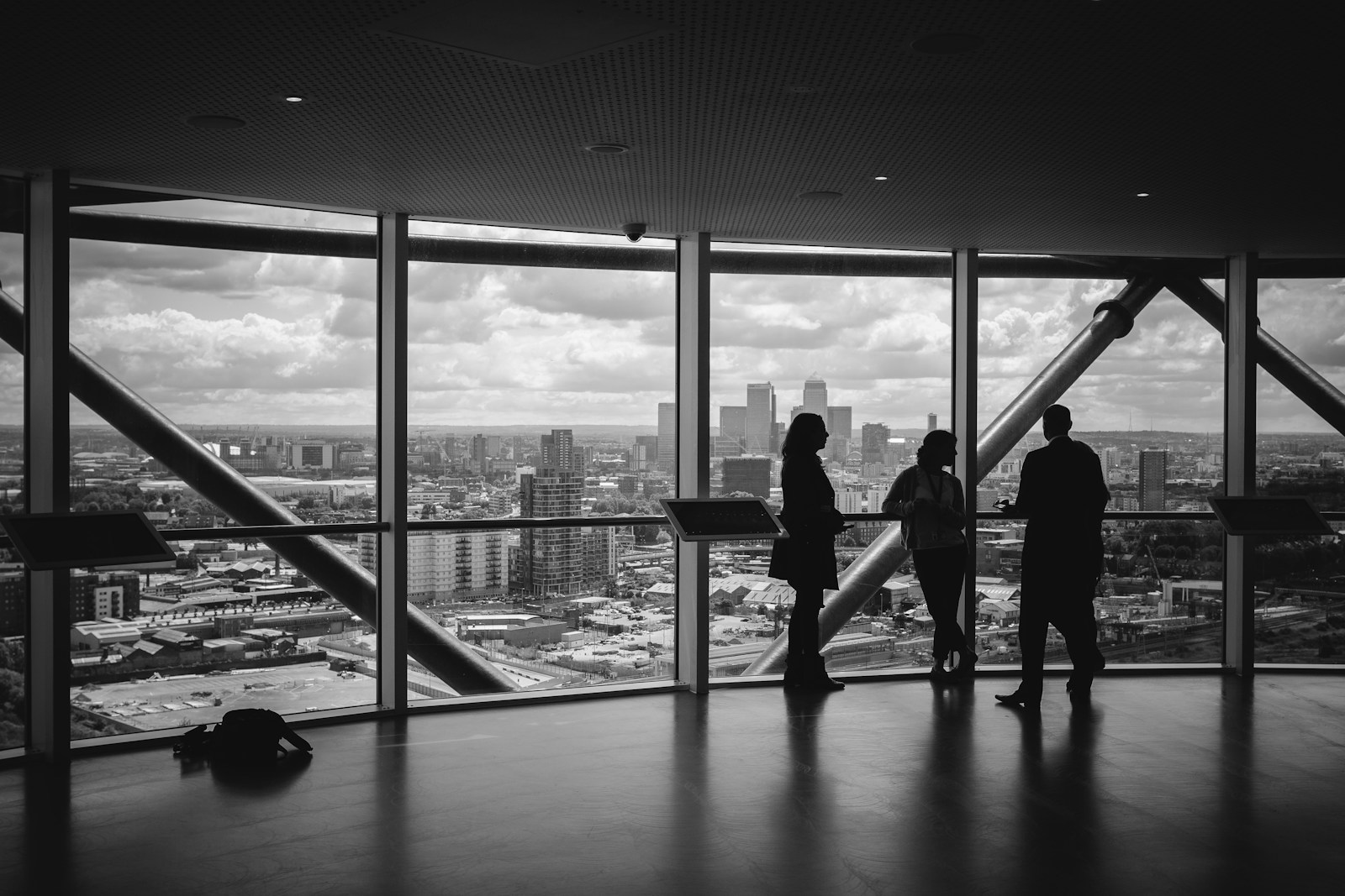 Figures overlooking a financial district skyline